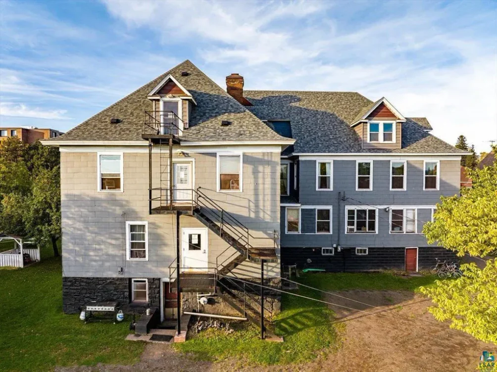 A two-storey clapboard and shingle building with an exterior staircase, Two Harbors