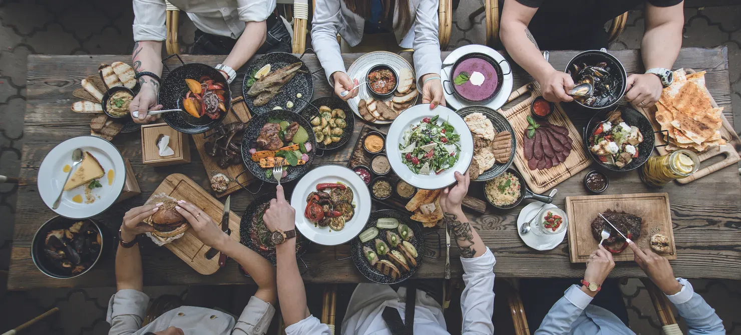 A shared table of dishes seen from above