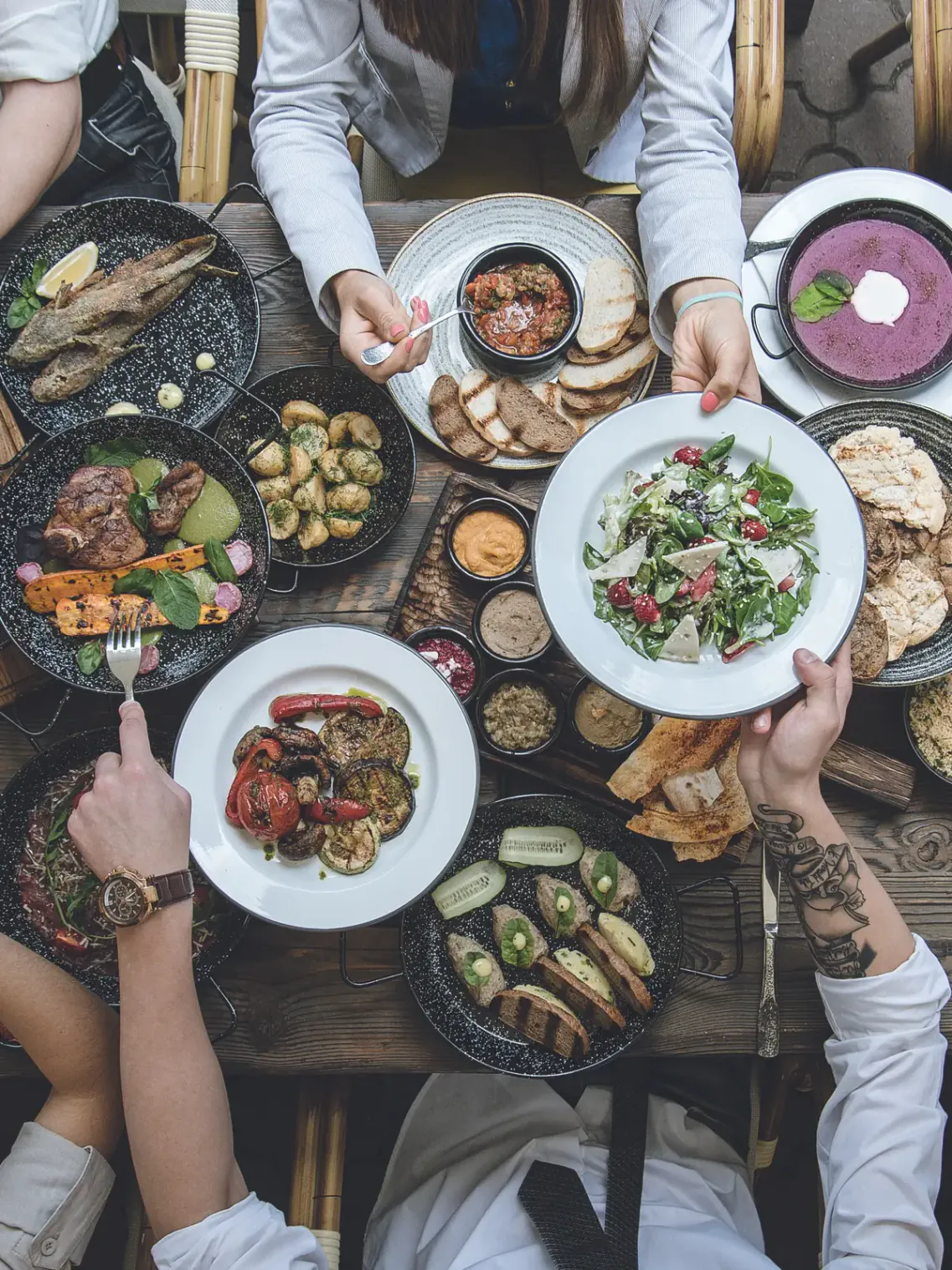 A shared table of dishes seen from above